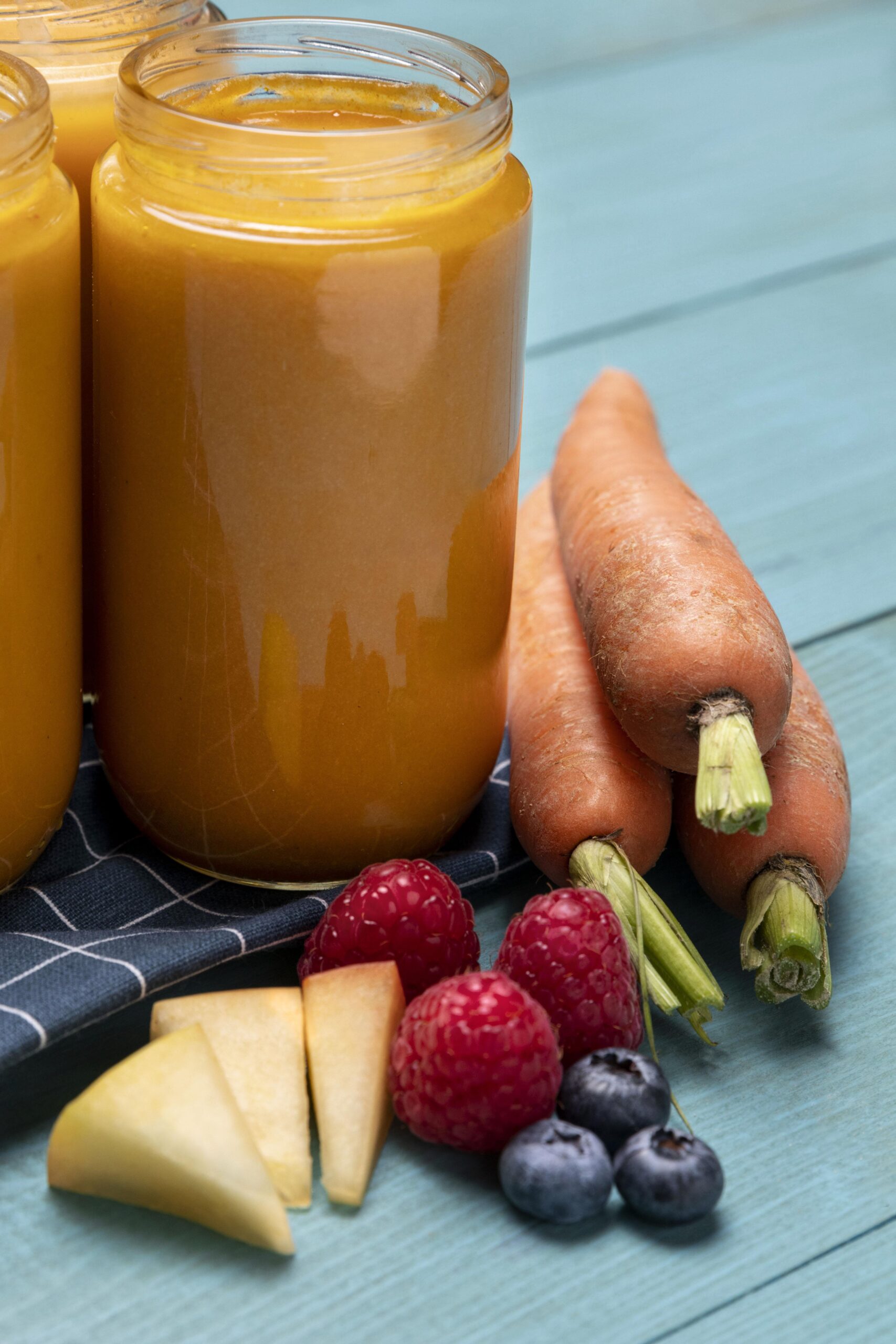high angle baby food jars with fruits carrots